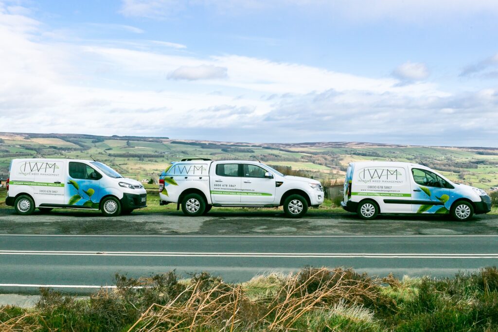 Invasive Weed Management Vans Parked In The Countryside