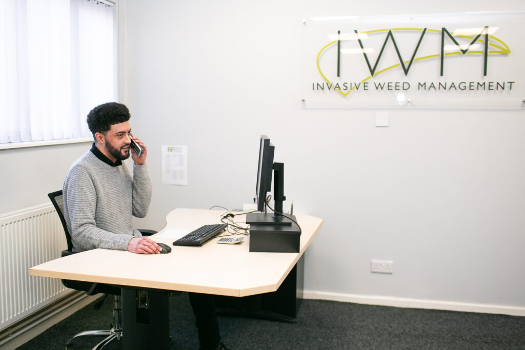 IWM team member on the phone at his desk