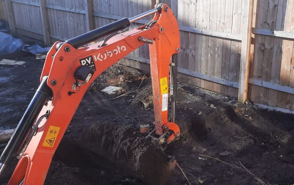 Mini Digger Excavating A Garden